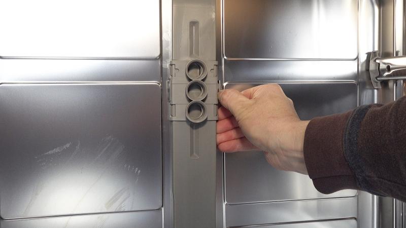 Halteclips des Zulaufs an der Rückwand lösen